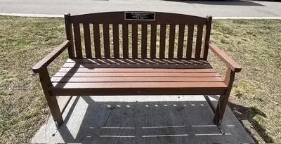 Brown memorial bench with plaque