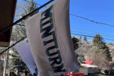 White flag with blue Minturn lettering.